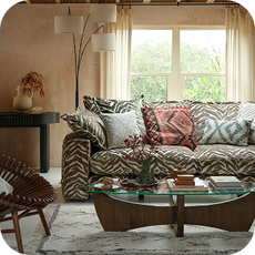 an animal print sofa with glass coffee table