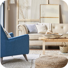 a white chesterfield sofa with a blue accent chair
