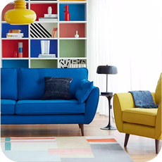a bright blue sofa with a bright yellow accent chair