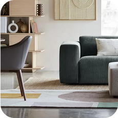 a large dull green sofa in a sundrenched room