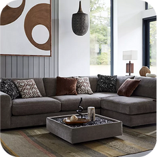a large dull brown sofa in a well lit room