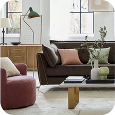 a dark brown sofa next to a dark pink accent chair