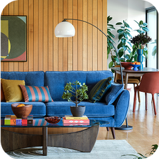 a bright blue sofa in a retro-themed room