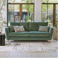 green sofa on a neutral pattern rug