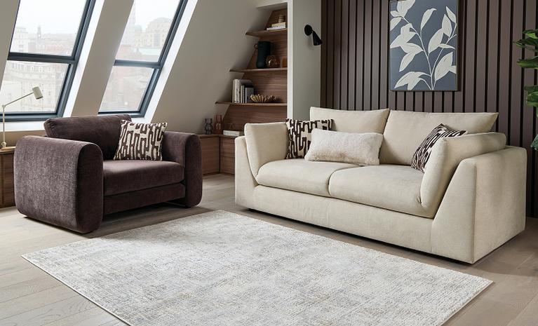 cream sofa with brown cuddler sofa in a neutral roomset