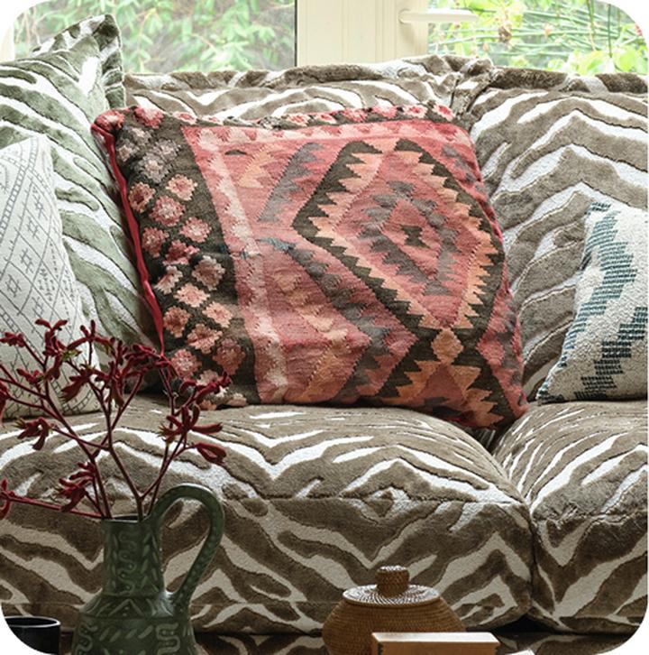 patterned scatter cushions on a zebra print sofa