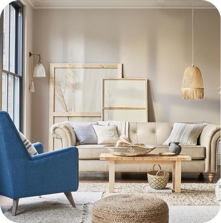 white sofa with a blue accent chair