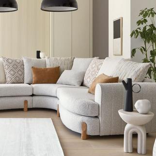 white boucle curved sofa with wooden feet