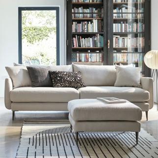 white boucle sofa with metal legs in a monochrome living space