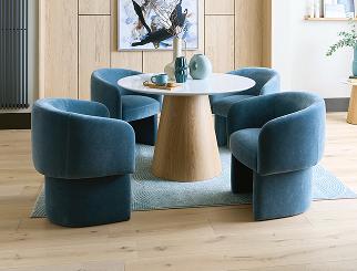 white and oak round dining table with blue fabric dining chairs