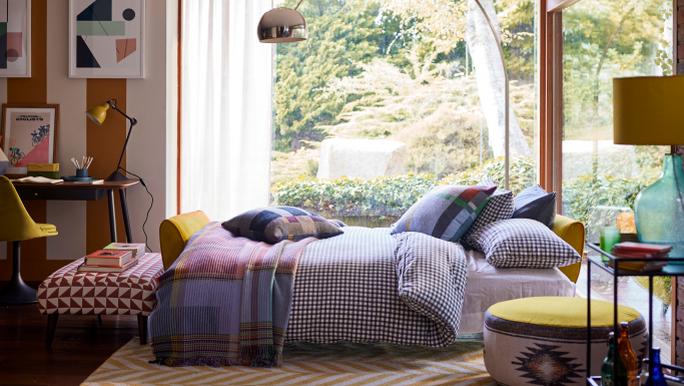 decorating on a budget zinc sofa bed in yellow with large round footstool