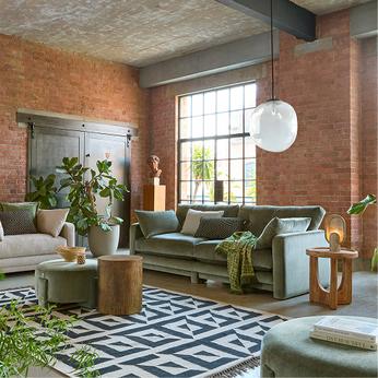 Green sofa in brick walled room