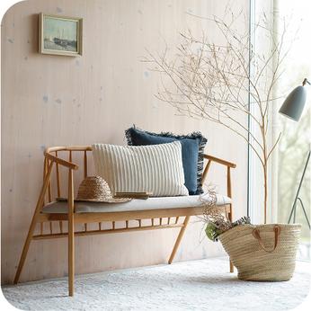 wooden spindle backed benchwith light pine coloured walls