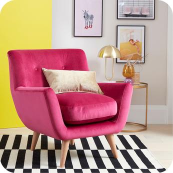 bright pink accent chair in a room with a bright yellow wall