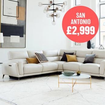 white coloured corner sofa with dark orange scatter cushions