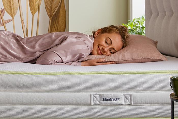 a person laying on bed smiling