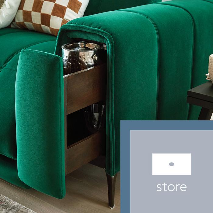 A green sofa with the storage arm pulled out