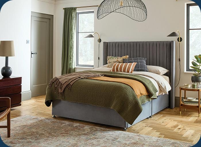Grey bed with orange and green accents