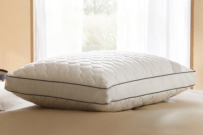 a pillow on a coral bed frame