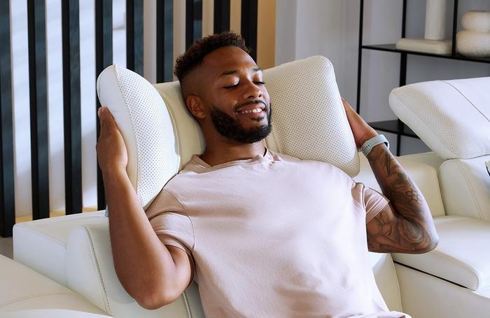 person reclining on a white sofa