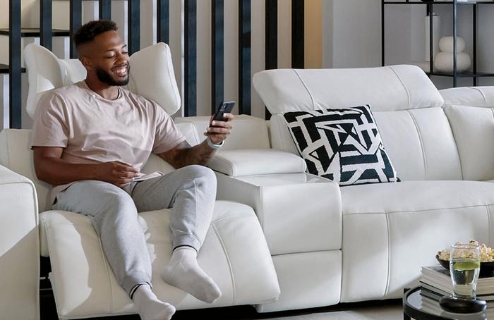 person reclining on a white sofa