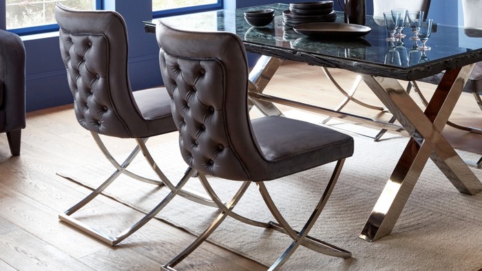 brown fabric dining chair under a glass dining table