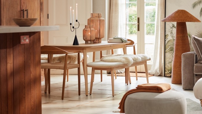 fabric topped dining bench under a wooden dining table