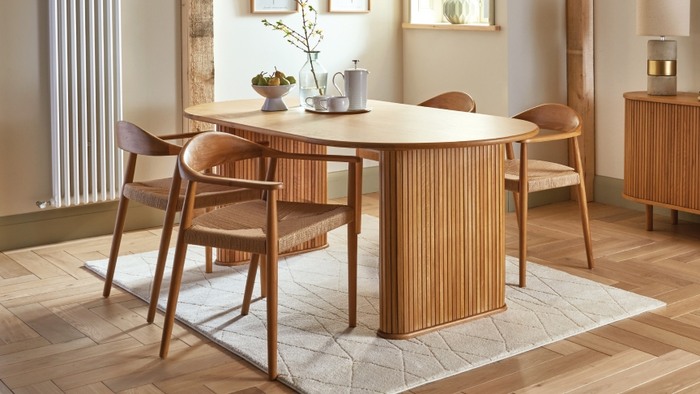 4 scandi style chairs under a wooden dining table