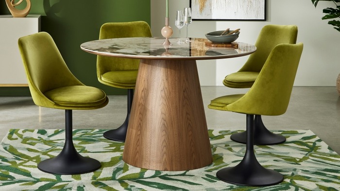 4 green chairs around a round dining table