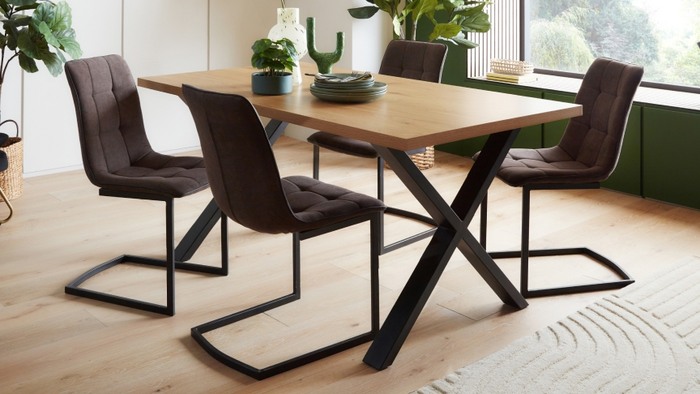 4 brown chairs around a wooden square dining table