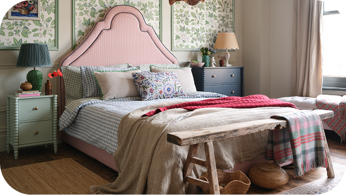 red pinstriped bedframe in a country house setting