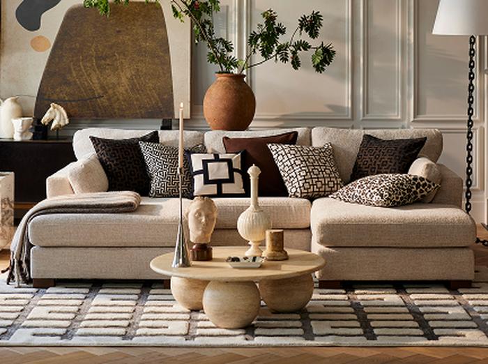 Black corner sofa with a cream rug