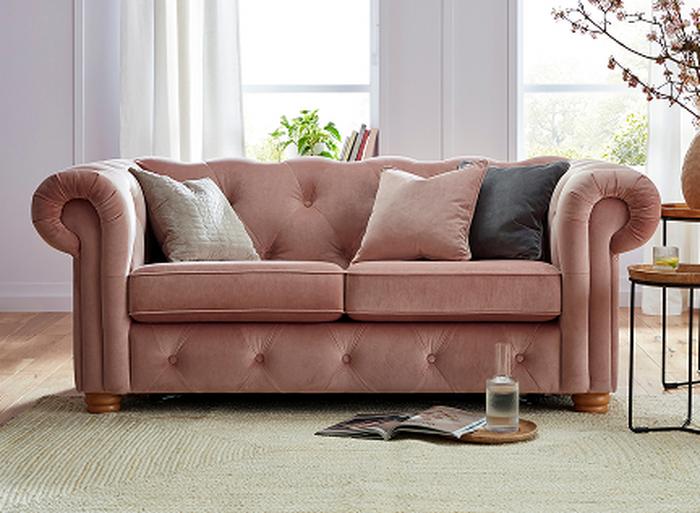 A blush sofa on a cream rug