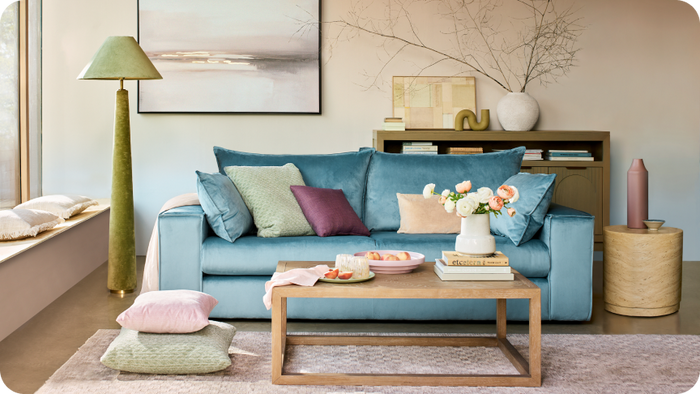 Lovise blue sofa with soft pink and green accents