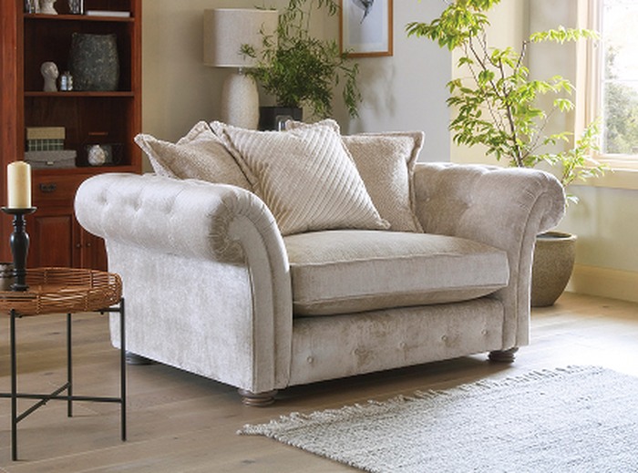 A cream chesterfield armchair 