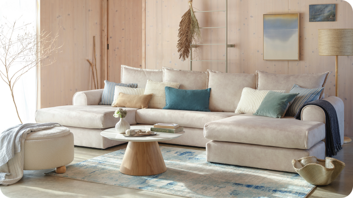 coastal themed room with a cream u shaped sofa