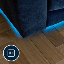 A blue light glowing under a sofa