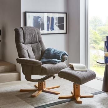 Dark grey swivel chair with matching footstool with wooden base 