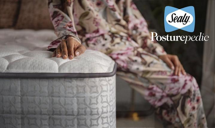 young women sat on top of a sealy mattress
