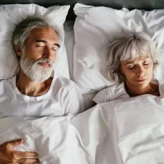 a older couple sleeping together on their backs