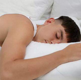 a young man sleeping on his front