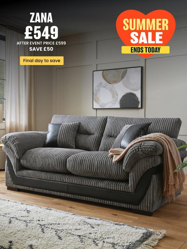 grey cord sofa with faux leather detailing on a wooden floored room setting