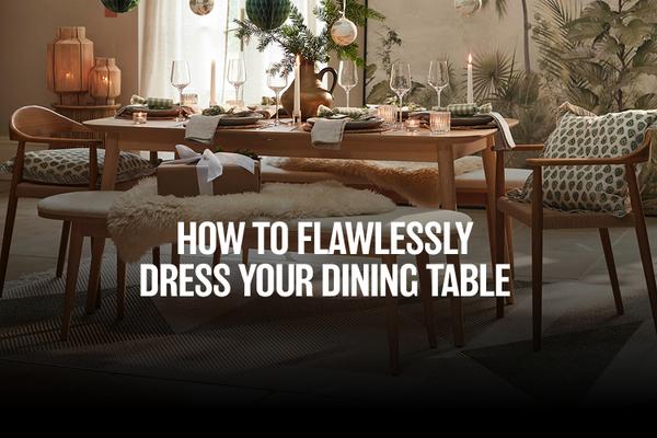 dining table dressed with wine glasses and accessories