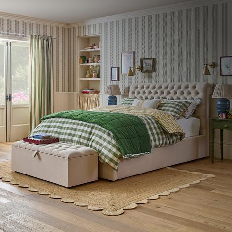 Cream bed with olive green gingham bedspread and blanket
