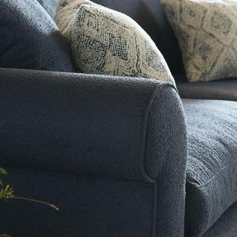 close up of a dark navy grey boucle sofa