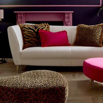 cream sofa with contrasting scatter cushions in pink and leopard print