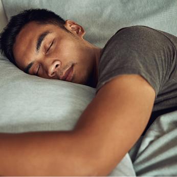 close up of a man side sleeping in bed
