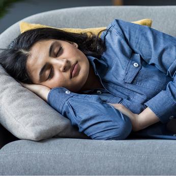close up of a women side sleeping on a sofa