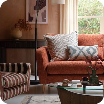 orange sofa next to a pattern striped accent chair