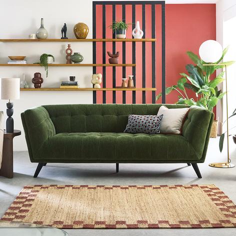 Green modular sofa on a beige textured rug